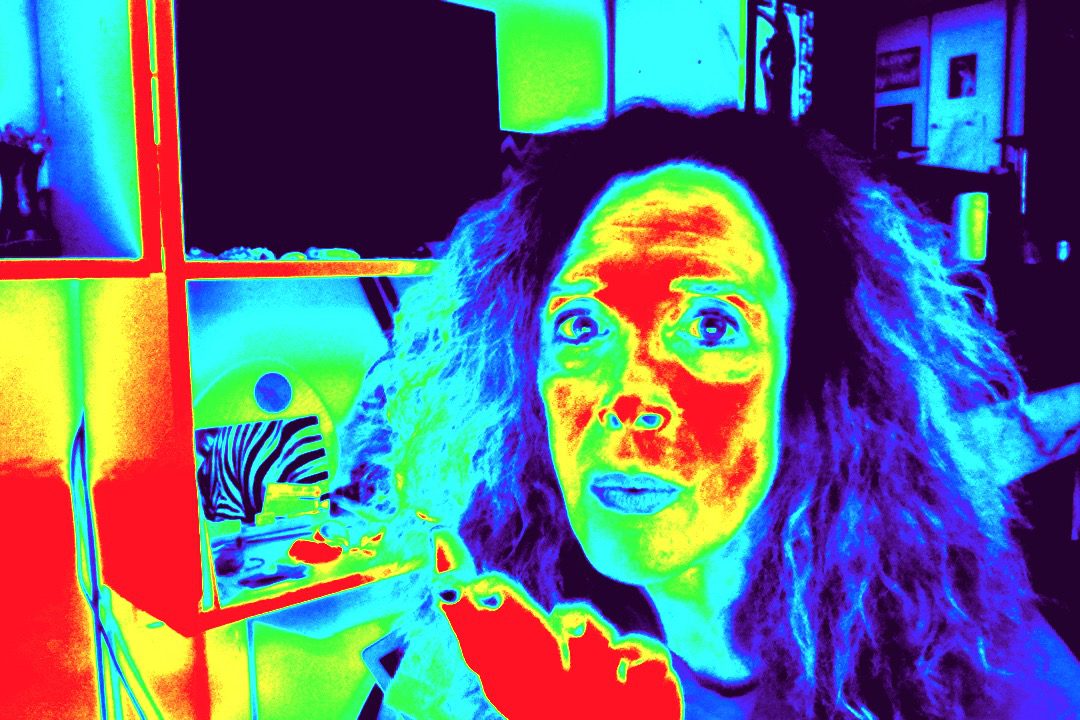 Thermal image of a person with vibrant colors highlighting heat patterns.